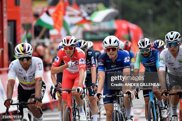 Team Decathlon-AG2R La Mondiale's Ben O'Connor, wearing the overall leader red jersey, crosses the finish line during the stage 18 of the Vuelta a...