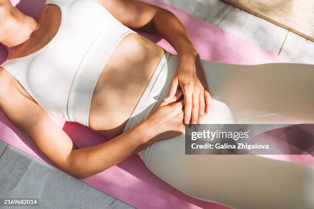 beautiful adult woman practices yoga outdoors - tapis de sol photos et images de collection