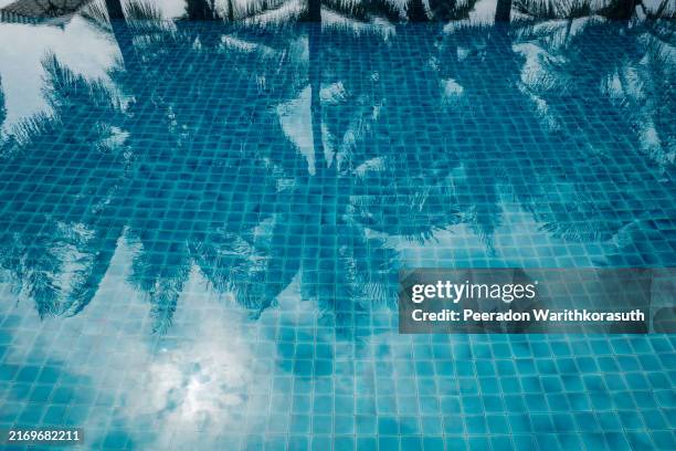 tranquil swimming pool with a mosaic tiled floor - teich stock-fotos und bilder