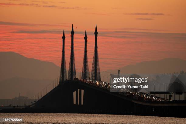 sunrise over penang bridge with a dramatic sky in the morning. - penang state stock pictures, royalty-free photos & images