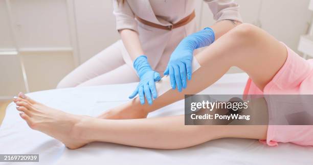 female wax leg hair removal - wax stock pictures, royalty-free photos & images