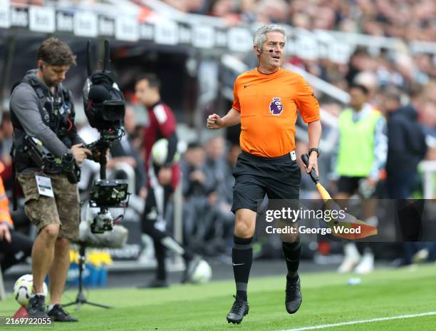 Assistant Referee, Darren Bond, is seen running the line after replacing former assistant referee, Ian Hussin, due to an injury during the Premier...