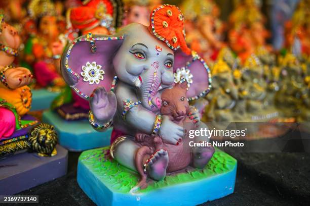 Artists are busy in a local workshop finishing an idol of the god Ganesha in preparation for the auspicious Indian festival of Ganesh Chaturthi in...