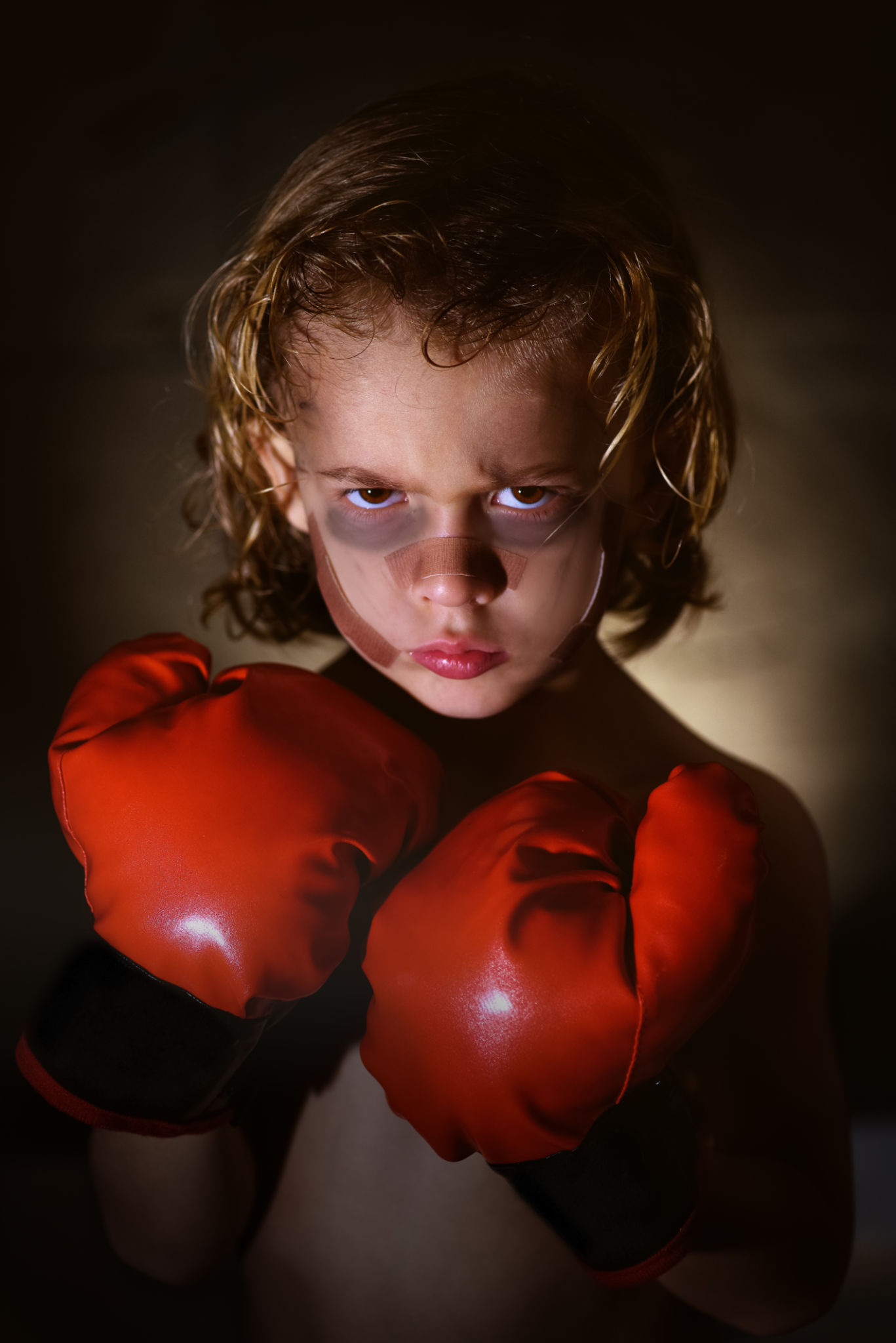 Boy with bruises in boxing gloves Boy with bruises in boxing gloves
