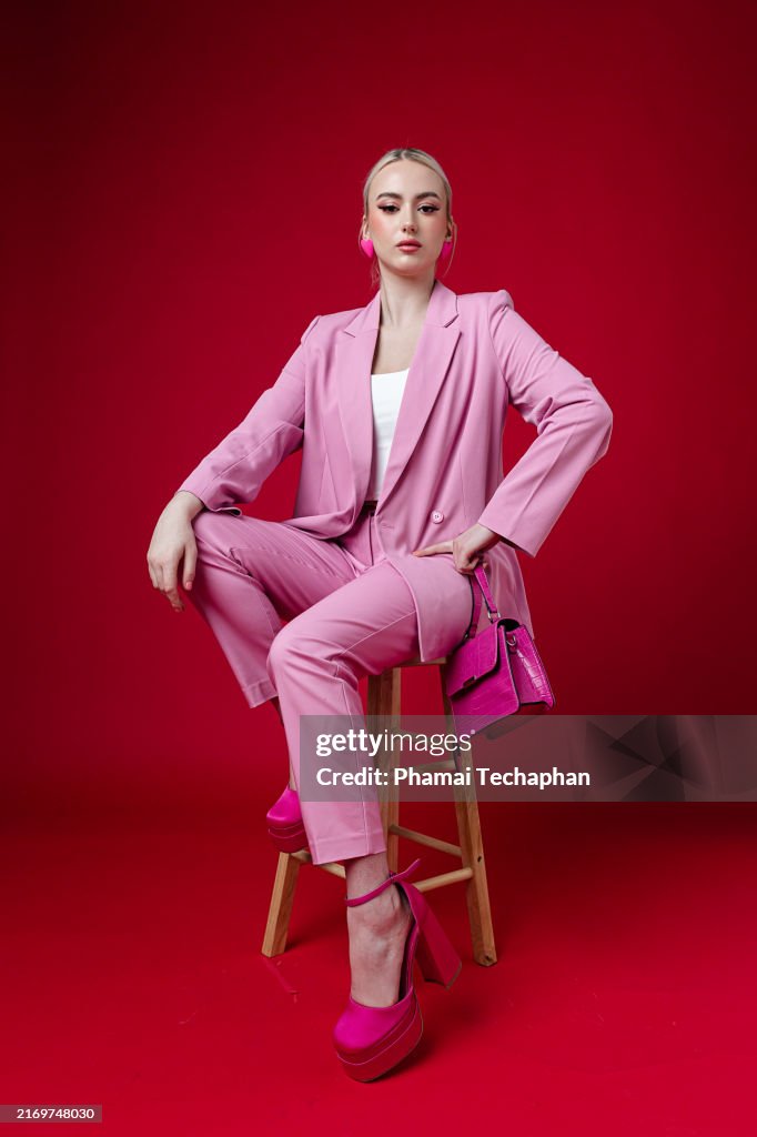 Beautiful elegant woman wearing pink suit