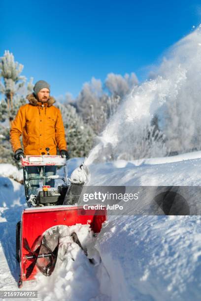 mid adult man using snowblower - winterdienst stock pictures, royalty-free photos & images