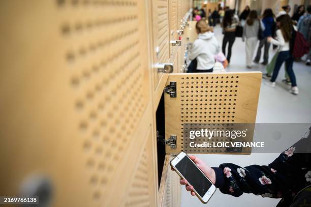 Student puts her mobile phone in her locker after switching it off, as it is a mandatory in the Auguste Brizeux highschool in Lorient, western...
