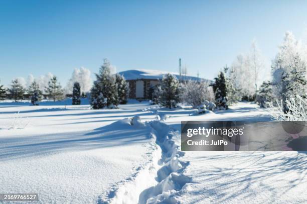 country house in deep snowdrifts - country house winter stock pictures, royalty-free photos & images