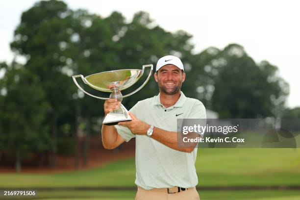 Scottie Scheffler of the United States celebrates with the FedExCup Trophy after winning the FedExCup and TOUR Championship at East Lake Golf Club on...