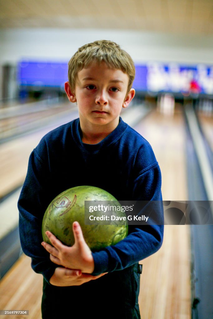 Front View of Boy Holding Bowling Ball