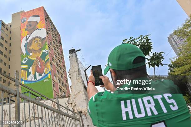 Fan takes pictures of a mural of Philadelphia Eagles quarterback Jalen Hurts and Green Bay Packers quarterback Jordan Love in Sao Paulo, Brazil, on...