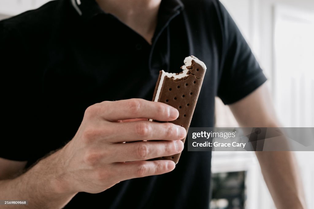 Man Enjoys an Ice Cream Sandwich