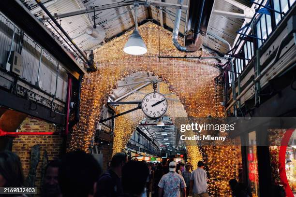 crowd of tourists walking inside chelsea market meatpacking district new york city - meatpacking district stock pictures, royalty-free photos & images