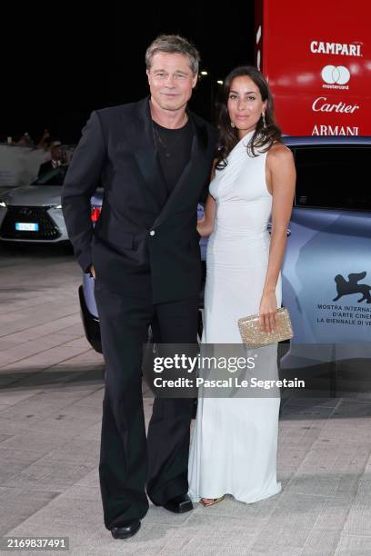 Brad Pitt and Ines de Ramon attends the red carpet of the "Wolfs" screening during the 81st Venice International Film Festival at Palazzo del Cinema...