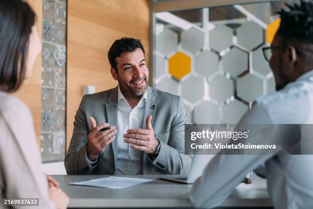 group of business persons talking in the office. - agente de seguros fotografías e imágenes de stock