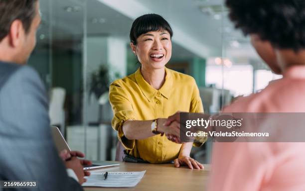 successful partnership - black realtor handshake stock pictures, royalty-free photos & images