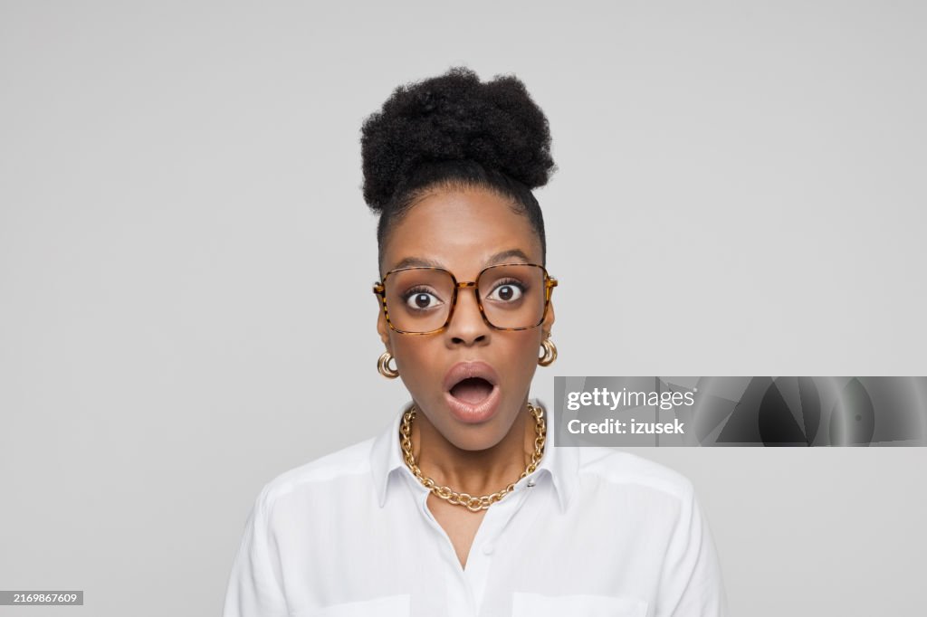 Headshot of shocked young businesswoman