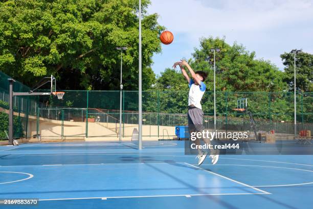 cute asian boy playing basketball - jump shot stock pictures, royalty-free photos & images