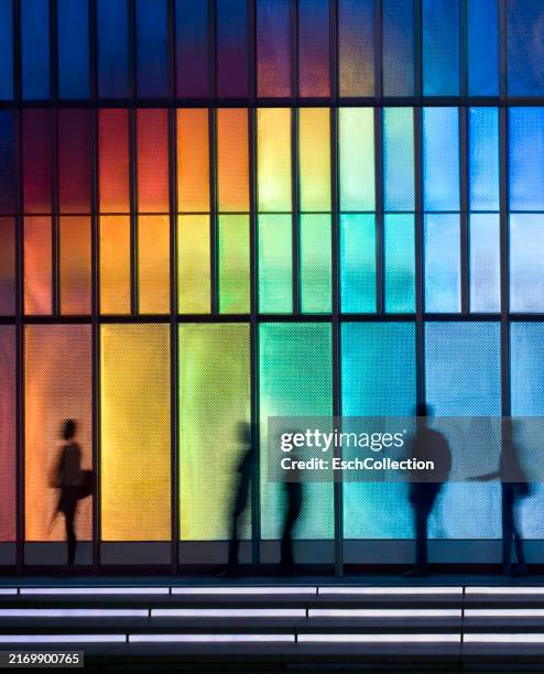 people passing colorful led illuminated facade - explorer de nouveaux territoires photos et images de collection