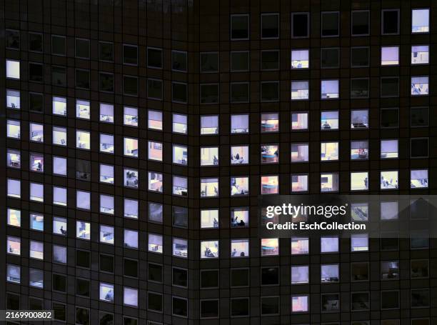 office building with illuminated window pattern, showing arrow sign to the right - the bigger picture stock pictures, royalty-free photos & images