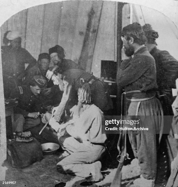 Army doctors performing an amputation in a make-shift hospital during the U.S. Civil War , c. 1863.