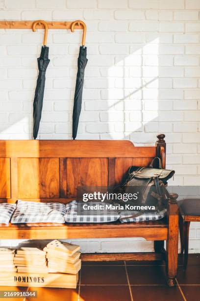 umbrellas hang on the wall in the corridor in old fashion style. - shabby chic stock-fotos und bilder