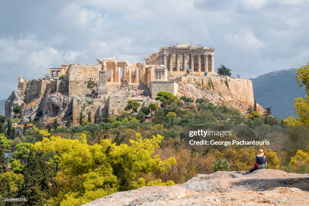 Woman with hat enjoying the view of the Acropolis of Athens