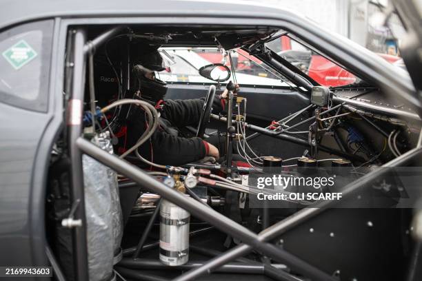 Driver Peter Kunc of Sweden prepares to compete in his Pro Modified car at The European Finals drag racing event held at the Santa Pod Raceway near...