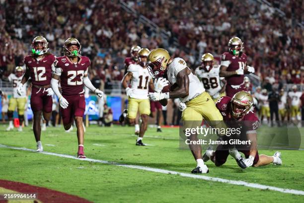 Kye Robichaux of the Boston College Eagles scores a touchdown against Blake Nichelson of the Florida State Seminoles during the second half of a game...