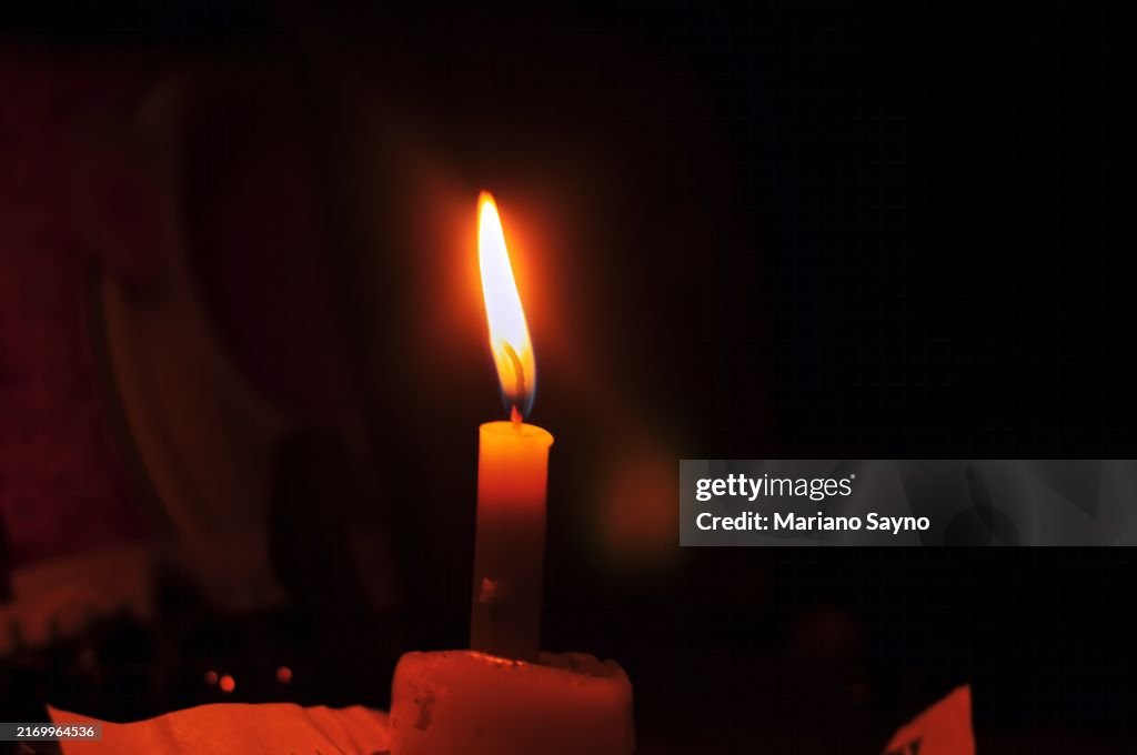 A candle wick lit with fire.