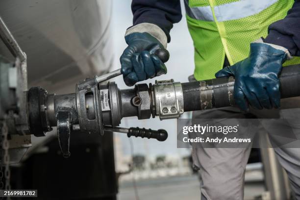engineer transferring fuel at depot - fuel storage tank stock pictures, royalty-free photos & images