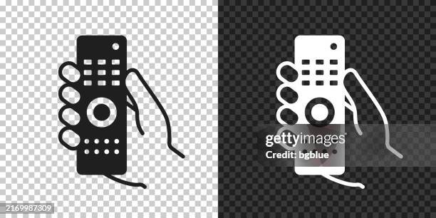 hand holding remote control. icon for design on blank background - remote controlled stock illustrations