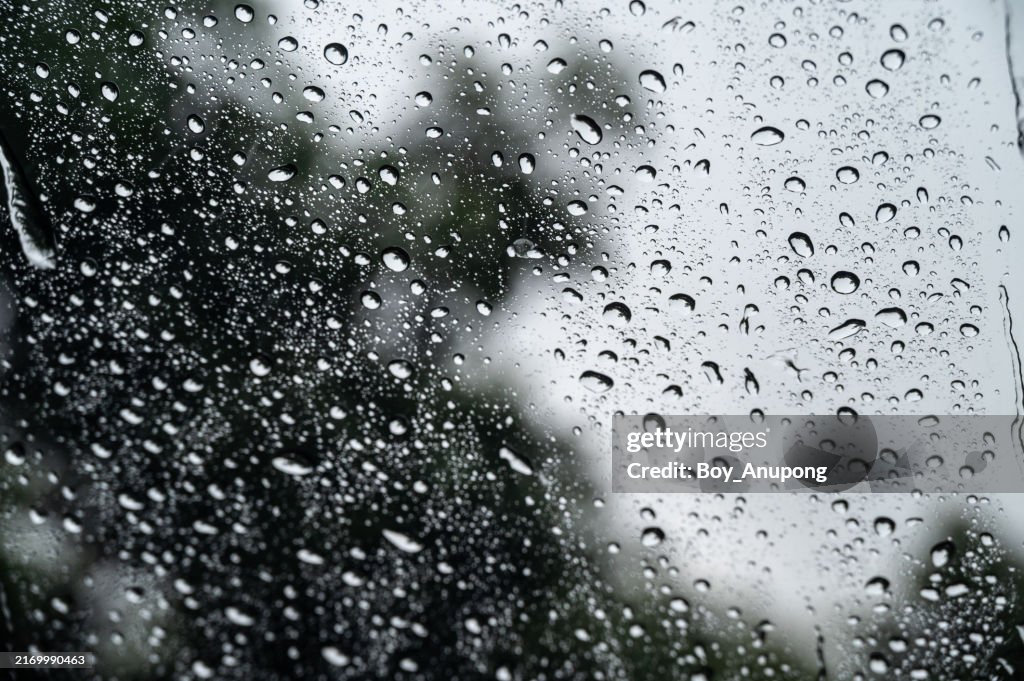 Dew drop on the car glass window during raining.