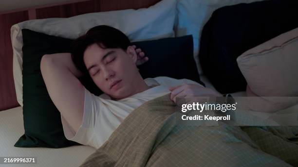 asian man sleeping at night - sleeping posture stock pictures, royalty-free photos & images