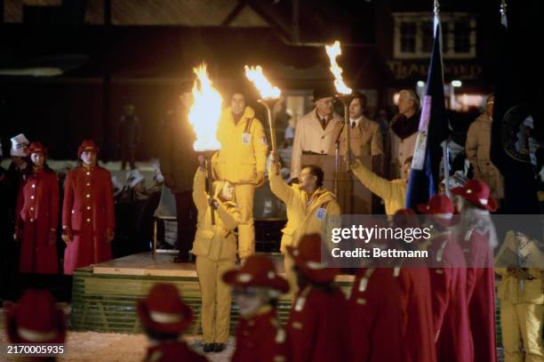 Three Olympic flames burn brightly during the opening ceremony of the Winter Olympic Games in Lake Placid, New York, February 8th 1980. The torch...