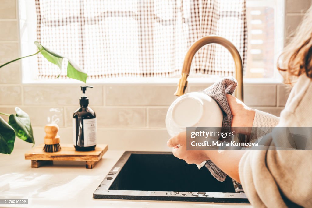 Woman washing dishes.