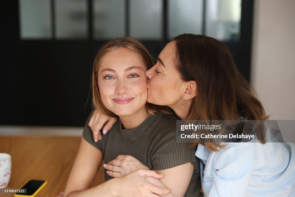 A 53 year old woman and her daughter at home