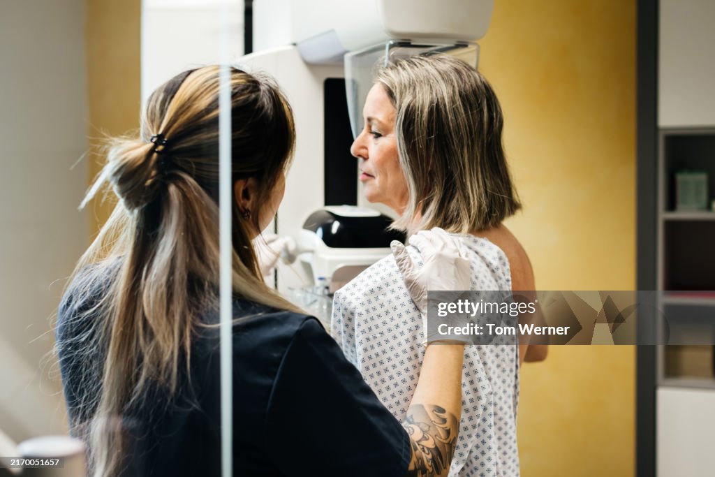 Nurse Assisting Patient During Mammogram