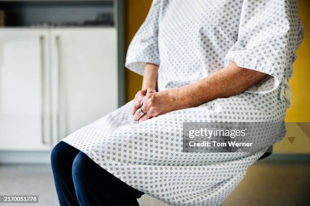 patient sitting calmly and waiting for her examination - wartezimmer stock-fotos und bilder