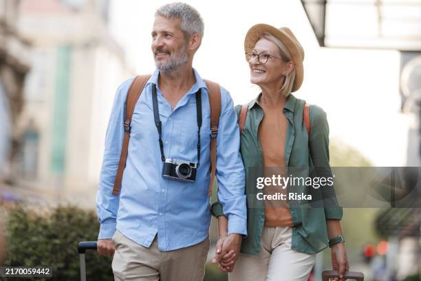 happy senior couple traveling together - travel insurance stock pictures, royalty-free photos & images