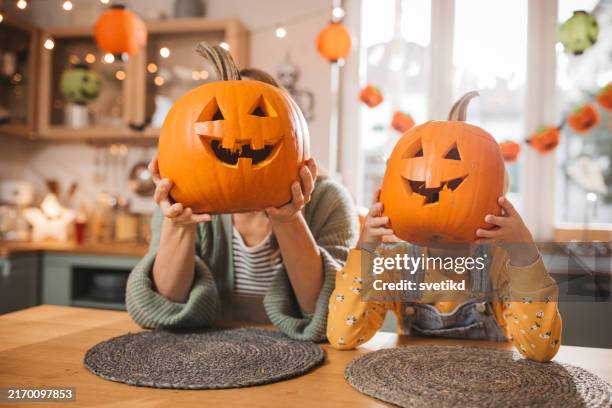 joyfully preparing for halloween - halloween carving pumpkins stock pictures, royalty-free photos & images