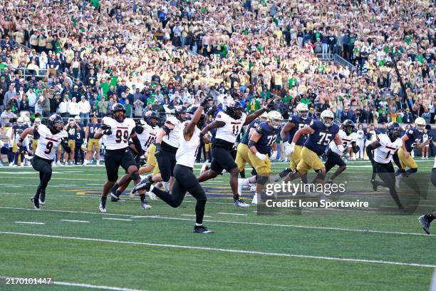 Northern Illinois Huskies defensive end Pierce Oppong and his teammates react to the upset victory against the Notre Dame Fighting Irish on September...
