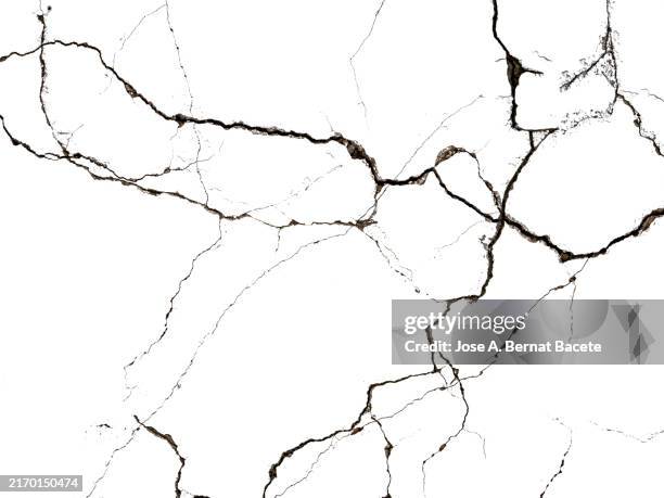 deep cracks on a white surface. - rotto foto e immagini stock