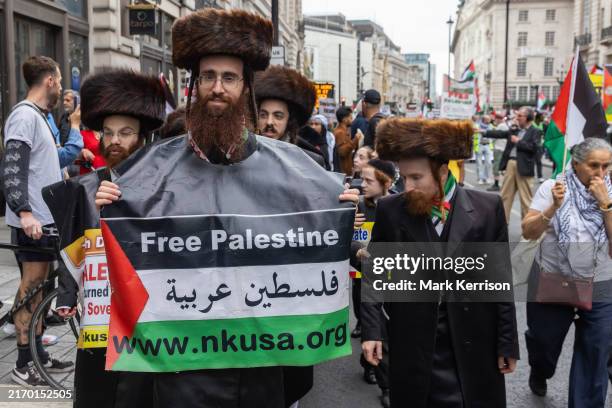 Ultra-Orthodox Jews from Neturei Karta line the route of pro-Palestinian protesters taking part in the 18th National March for Palestine...