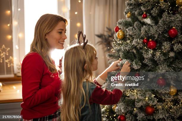sweet holidays at home - decorating the christmas tree stock pictures, royalty-free photos & images