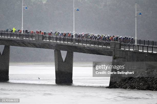 General view of the peloton crossing a bridge under heavy rain during the La Vuelta - 79th Tour of Spain 2024, Stage 17 a 141.5km stage Arnuero to...