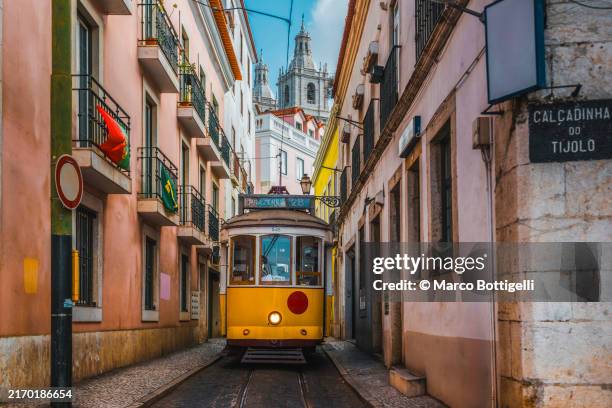 traditional yellow tramway in lisbon, portugal - lisbon stock pictures, royalty-free photos & images