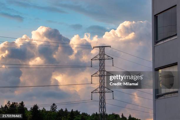 electricity pylon, cables, sunset clouds and window reflections - elnät bildbanksfoton och bilder