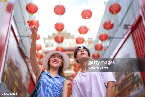 young asian travelers walking on footpath over china town, bangkok, thailand, travel holiday relaxation concept - adulation stock pictures, royalty-free photos & images
