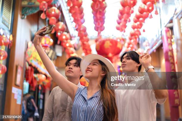 young asian travelers walking on footpath over china town, bangkok, thailand, travel holiday relaxation concept - adulation stock pictures, royalty-free photos & images